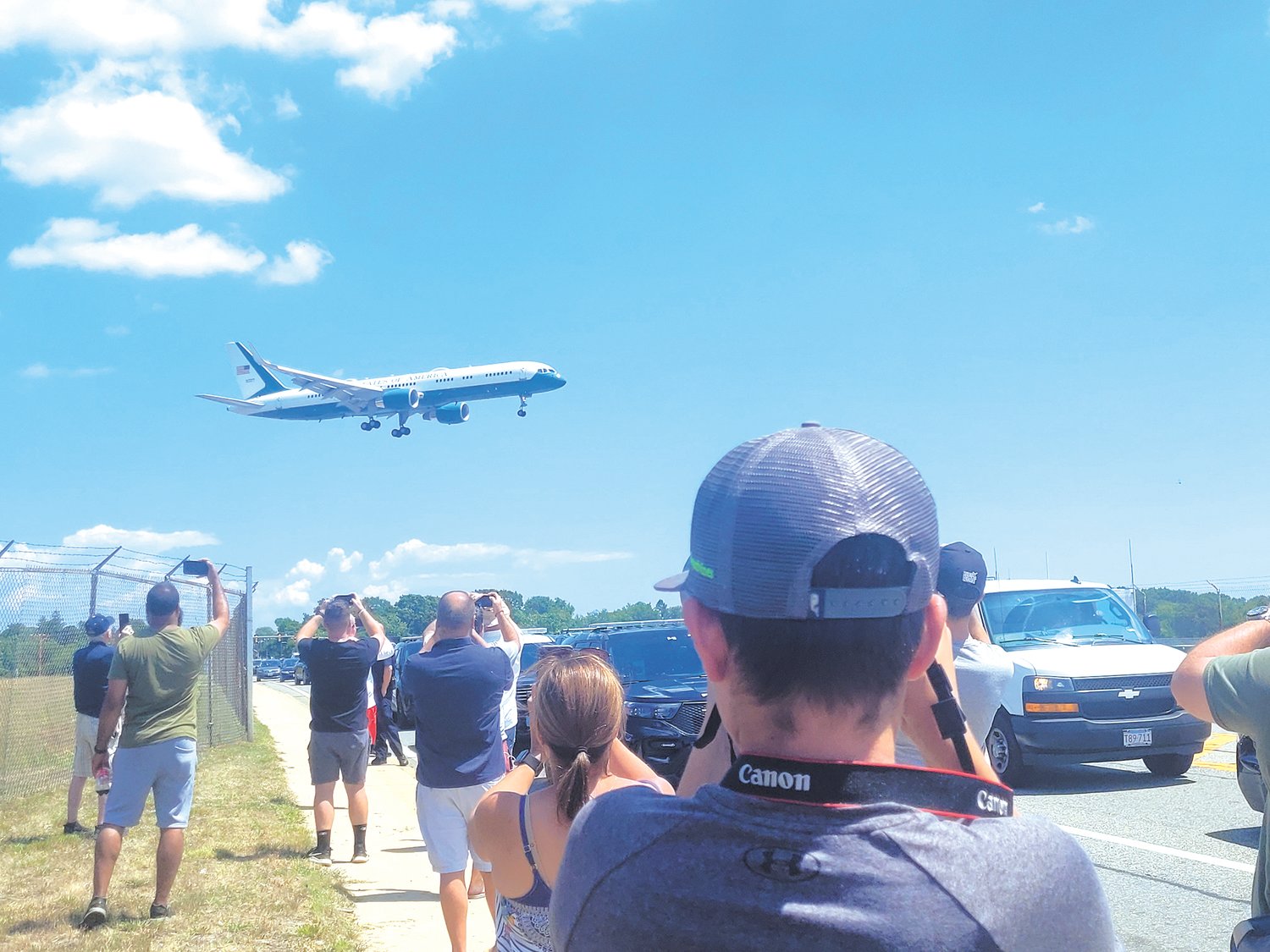 Jake Fernandes, 13, of New Bedford, gripped his camera and heavy, long telephoto lens as he jockeyed for position along Airport Road.